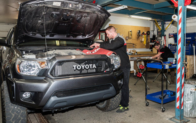 mechanic repairing car in garage