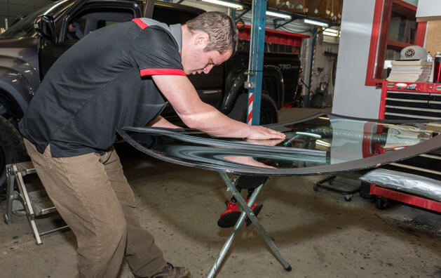 mechanic polishing a glass