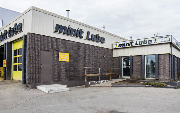 Gray main entrance with black, Minit Lube sign