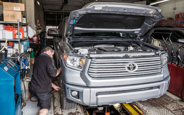 mechanic working on a van in the garage