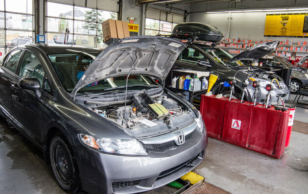 car showing its engine inside Minit Lube garage