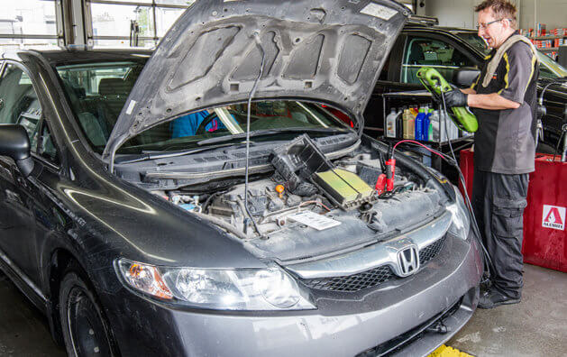 car showing its engine inside the Minit Lube garage
