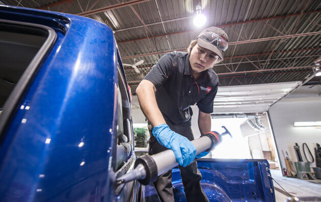 employee working in car front glass