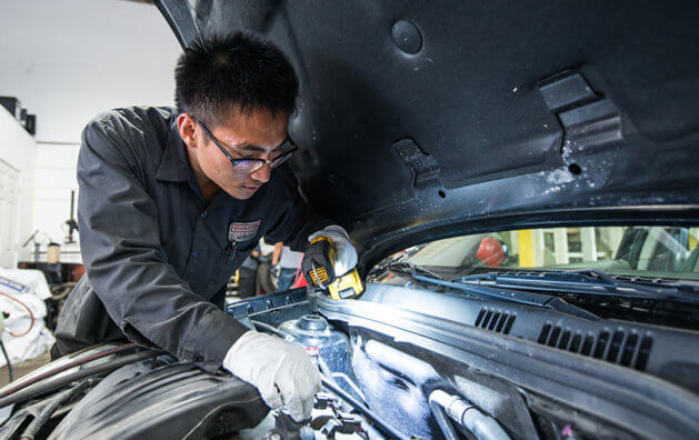 mechanic repairing car engine