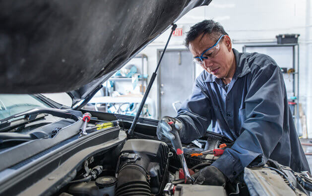 mechanic repairing car engine