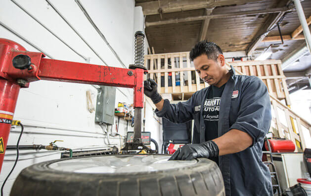 mechanic repairing a tire