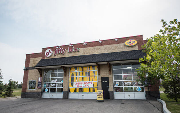 The front of Jiffy Lube Chestermere with three glass gates, and the word 