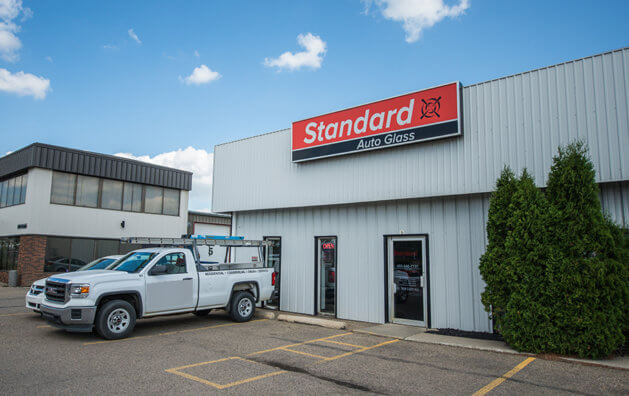 front of the company, white walls, car parked near the entrance door
