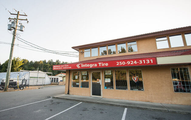 Outside the company, orange walls, red strip integra sign, glass door and windows.